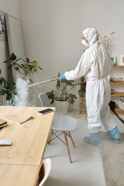 Minimalist desk with a focus on a multipurpose cleaner, office supplies, and storage solutions.